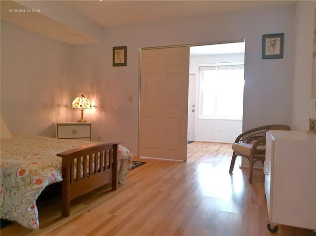 a view of a room with wooden floor and bench