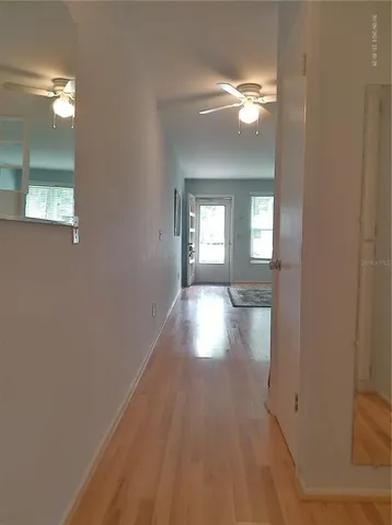 a view of a room that has wooden floor and a window