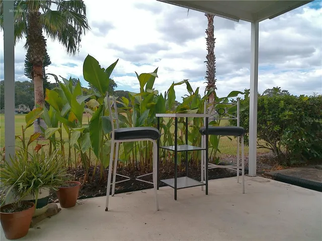 a view of a lake with a table and chairs