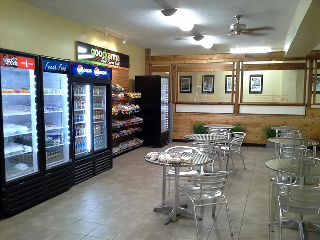 an aerial view of a city with lots of residential buildings ocean and mountain view in back