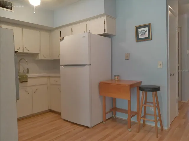 a white refrigerator freezer sitting in a kitchen
