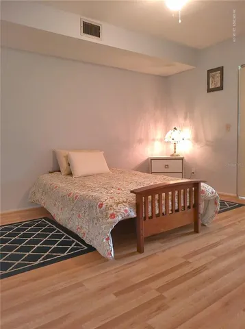 a view of a livingroom with wooden floor and a window
