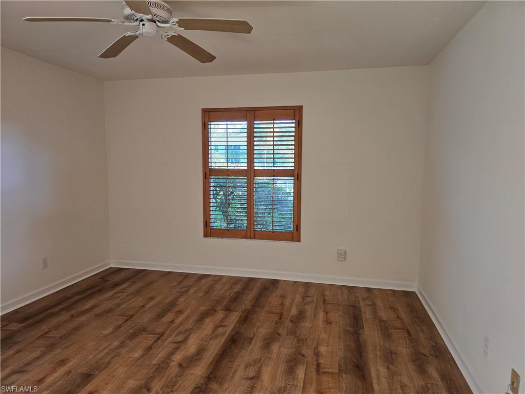 5737 Whitaker Road, Unit C104 Naples, FL 34112 - Photo 18 of 34 Master bedroom with ceiling fan and dark hardwood / wood-style floors