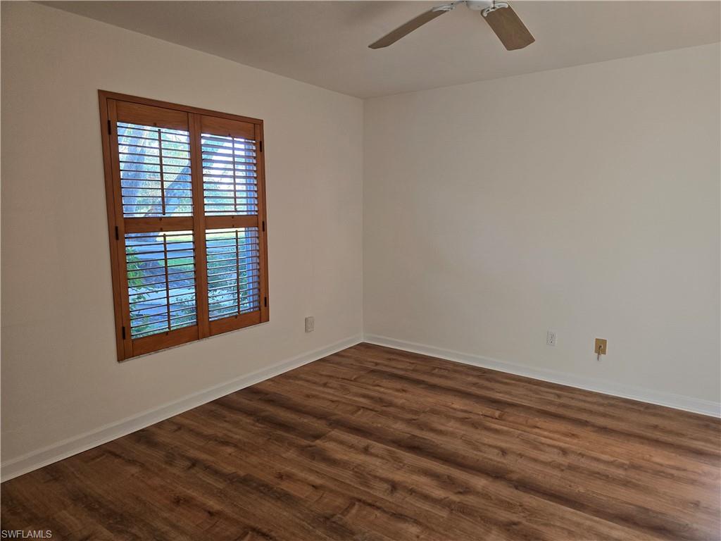 5737 Whitaker Road, Unit C104 Naples, FL 34112 - Photo 19 of 34 Master bedroom with dark wood-type flooring and ceiling fan
