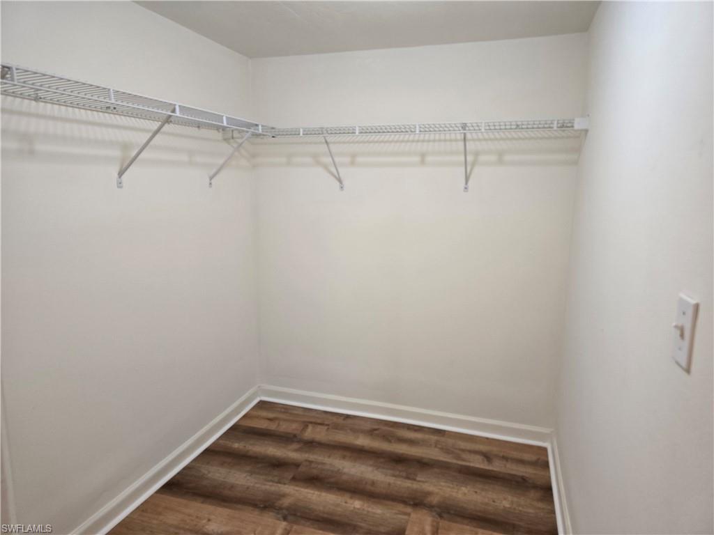 5737 Whitaker Road, Unit C104 Naples, FL 34112 - Photo 23 of 34 Spacious closet featuring wood-type flooring