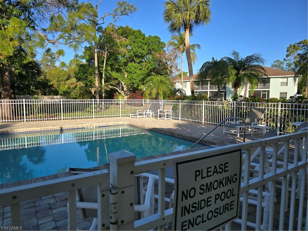 5737 Whitaker Road, Unit C104 Naples, FL 34112 - Photo 3 of 34 View of swimming pool with a patio area