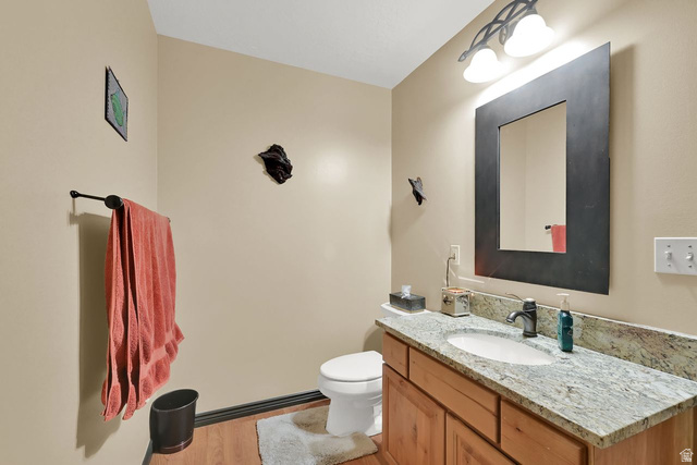 655 Ogden Canyon Road Ogden, UT 84401 - Photo 20 of 50 Bathroom featuring a wood-finish vanity with granite-style countertop, undermount sink, and dark hardware