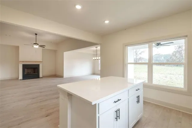a view of an empty room with a window and fireplace