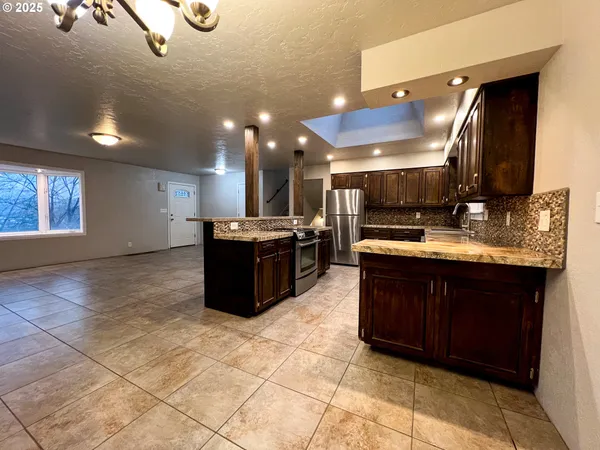 a kitchen with stainless steel appliances granite countertop a sink and cabinets