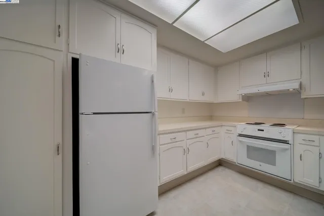 a kitchen with granite countertop a sink and cabinets