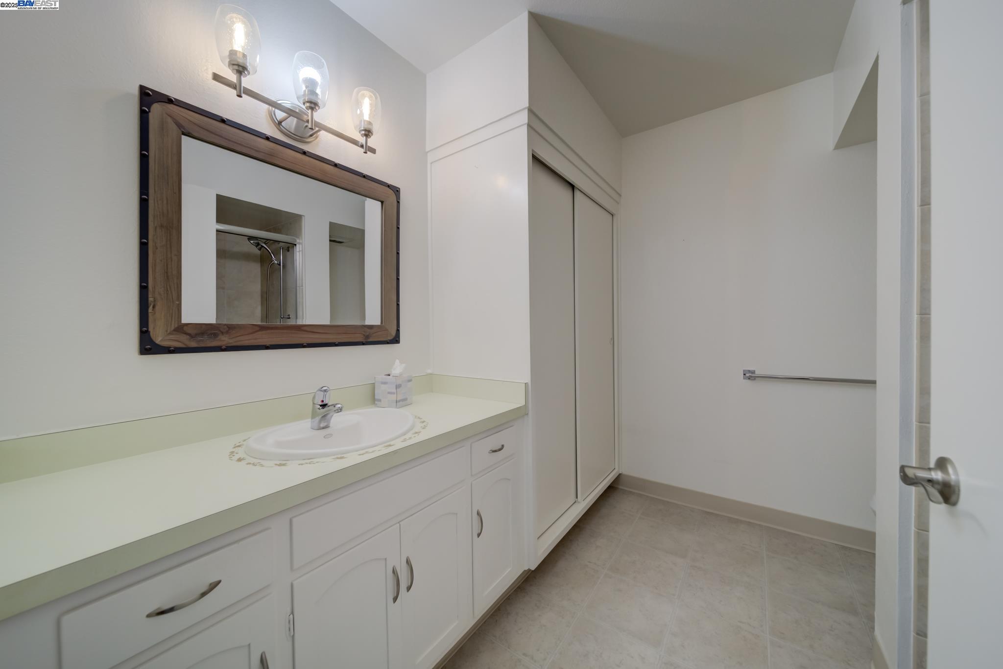 1708 Golden Rain Road, Unit 3 Walnut Creek, CA 94595 - Photo 20 of 23 a bathroom with a toilet sink and mirror