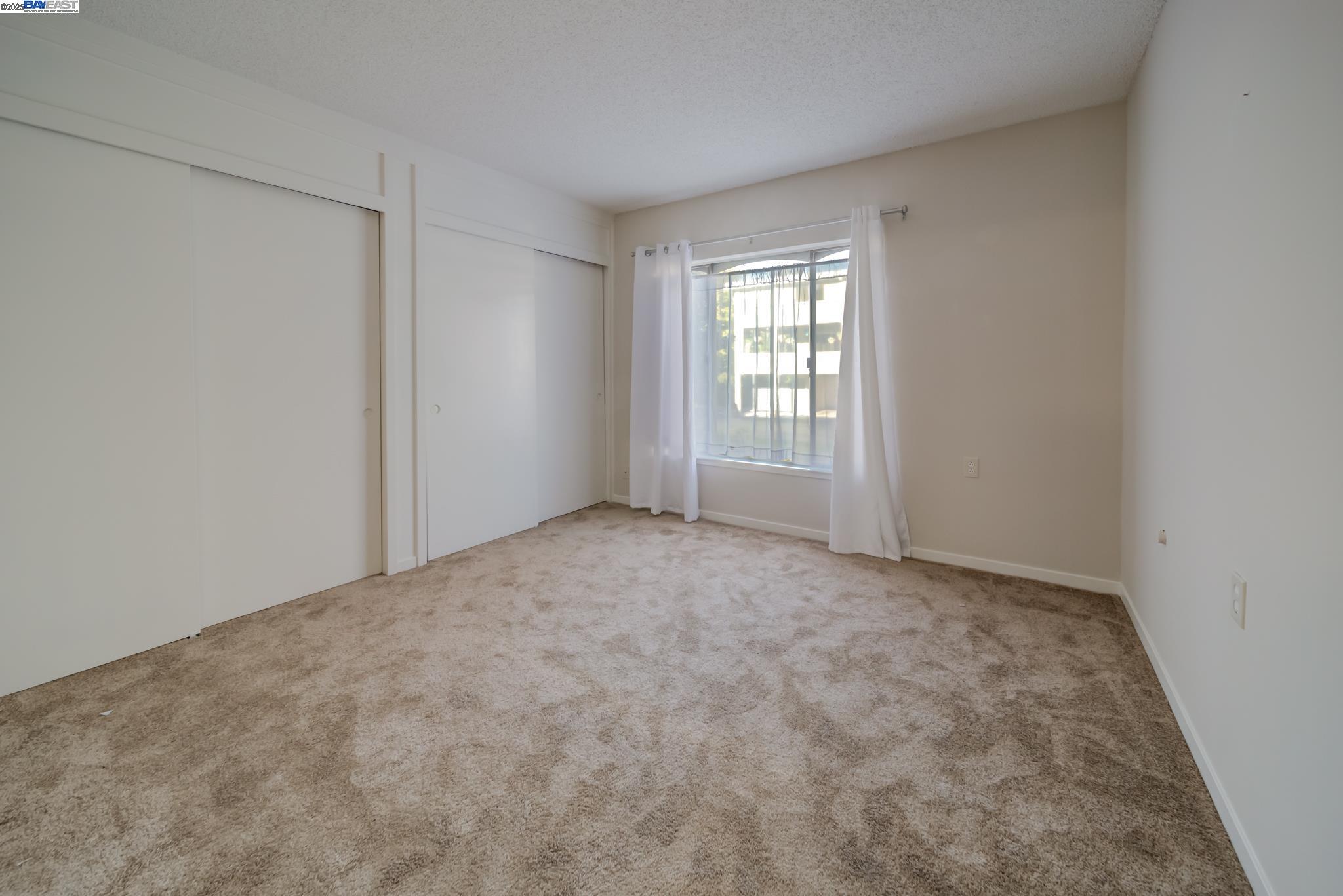 1708 Golden Rain Road, Unit 3 Walnut Creek, CA 94595 - Photo 22 of 23 an empty room with windows