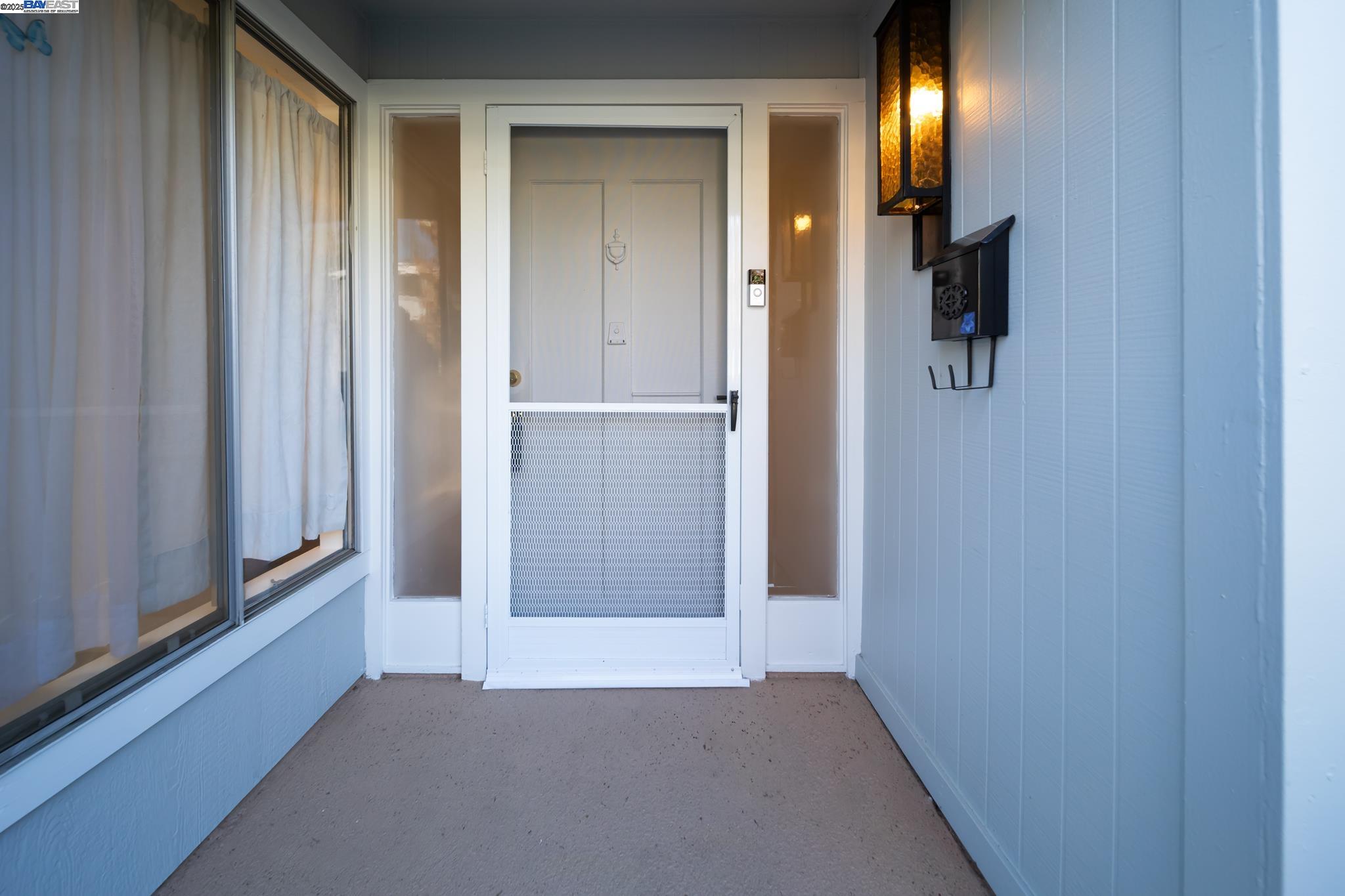 1708 Golden Rain Road, Unit 3 Walnut Creek, CA 94595 - Photo 3 of 23 a view of a hallway with lamp