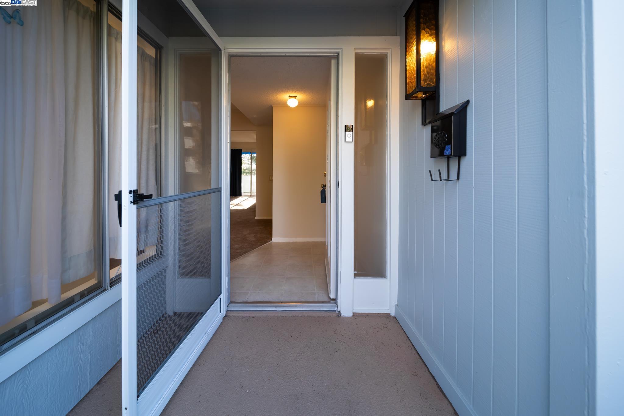 1708 Golden Rain Road, Unit 3 Walnut Creek, CA 94595 - Photo 5 of 23 a view of a hallway with wooden floor and staircase