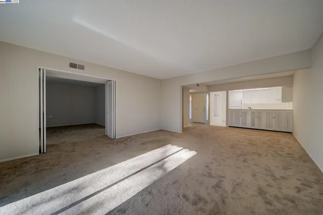 a view of an empty room and closet