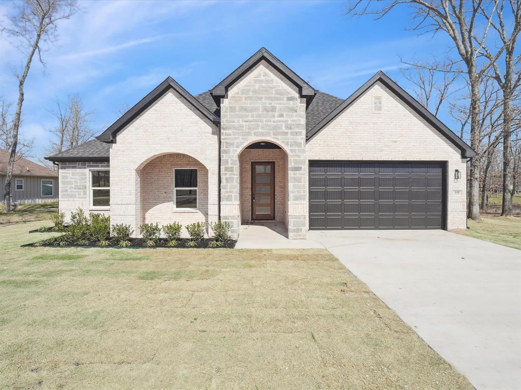 a front view of a house with garden