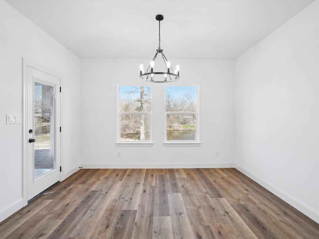 448 Rs County Road Alba, TX 75410 - Photo 21 of 29 a view of a room with wooden floor chandelier and windows