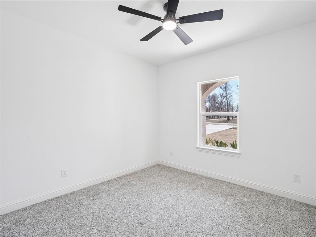 448 Rs County Road Alba, TX 75410 - Photo 7 of 29 an empty room with a window and a fan