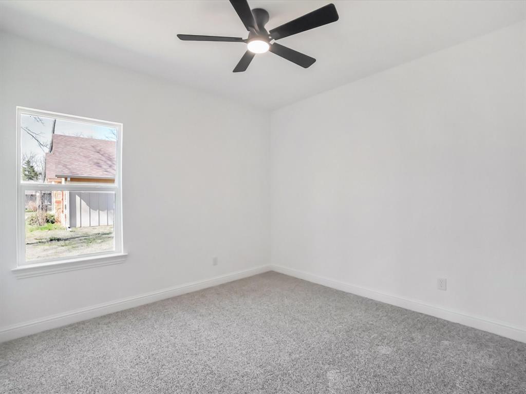 448 Rs County Road Alba, TX 75410 - Photo 10 of 29 an empty room with a window and a fan