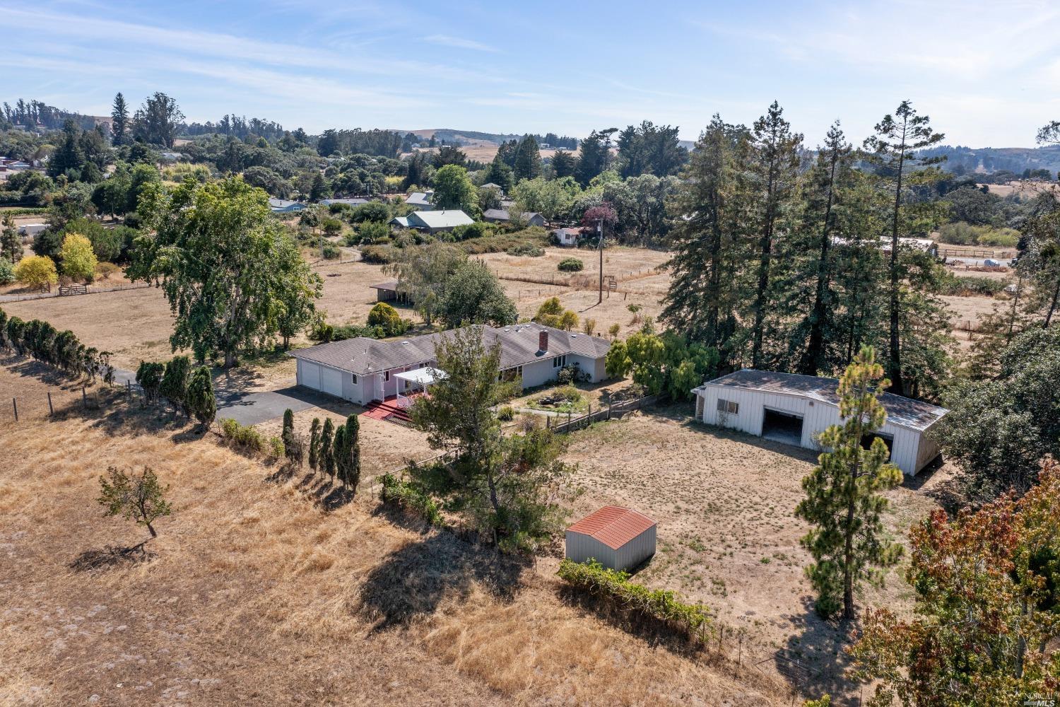 a view of a house with a yard and sitting area