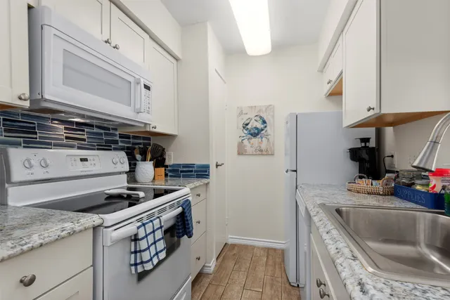 a kitchen with stainless steel appliances granite countertop a stove and a sink