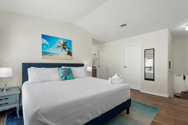 a bedroom with a bed and a lamp on table