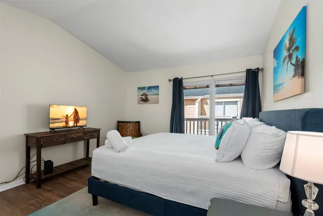 a bedroom with a bed a bookshelf and a window