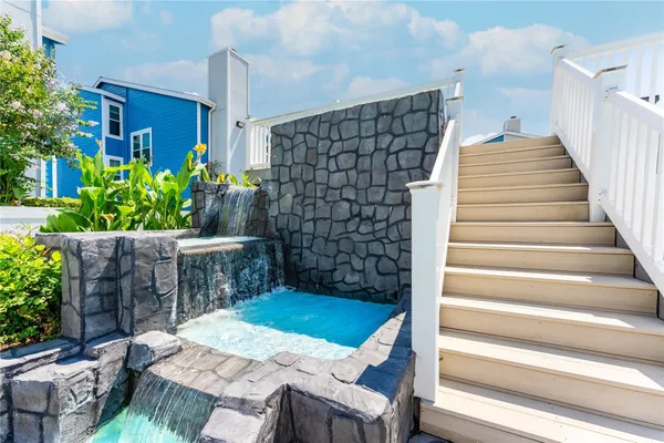 a view of a roof deck with couches and sky view