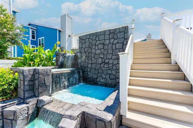 a view of a roof deck with couches and sky view