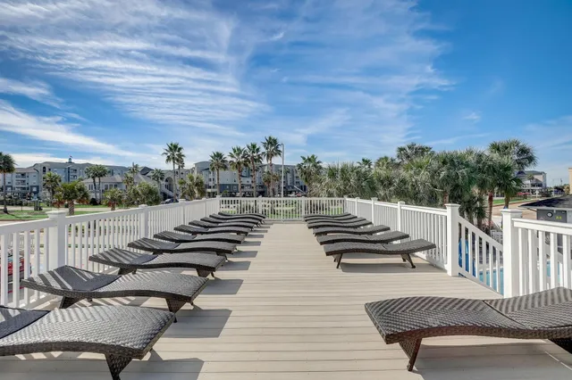 a view of swimming pool with outdoor seating and plants