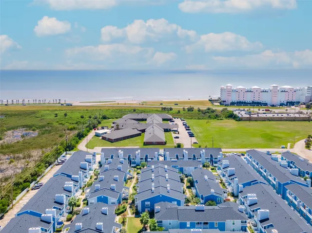 a view of a house with a yard and potted plants