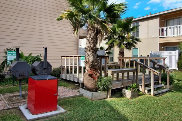 a view of a patio with table and chairs