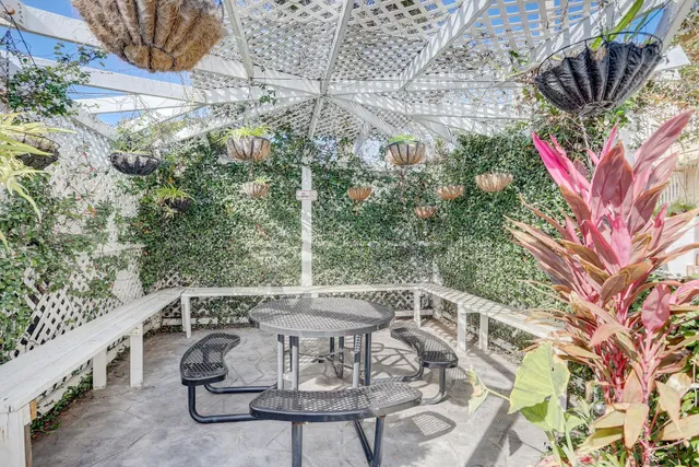 a front view of a house with a tree