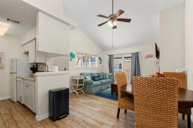 a living room with furniture a fireplace and a chandelier