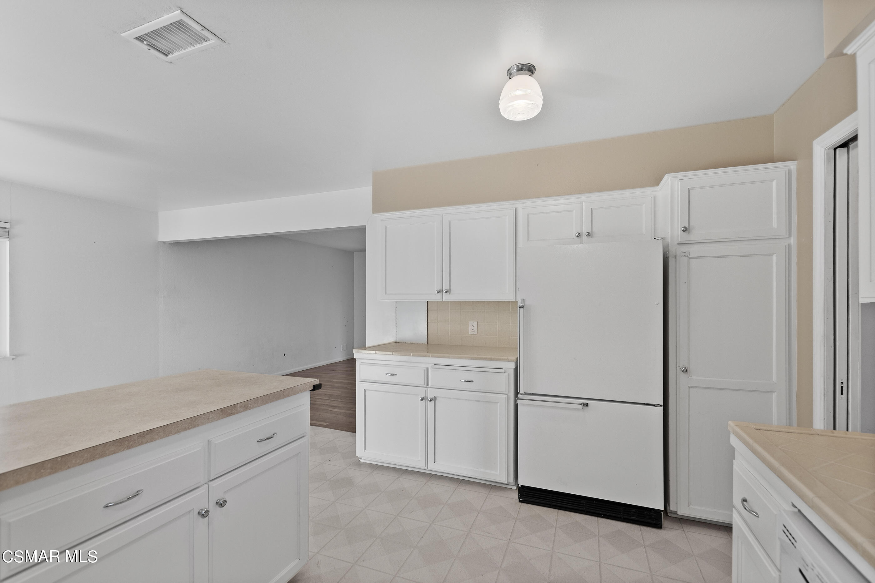 2772 Harrington Road Simi Valley, CA 93065 - Photo 12 of 36 a kitchen with white cabinets and white appliances