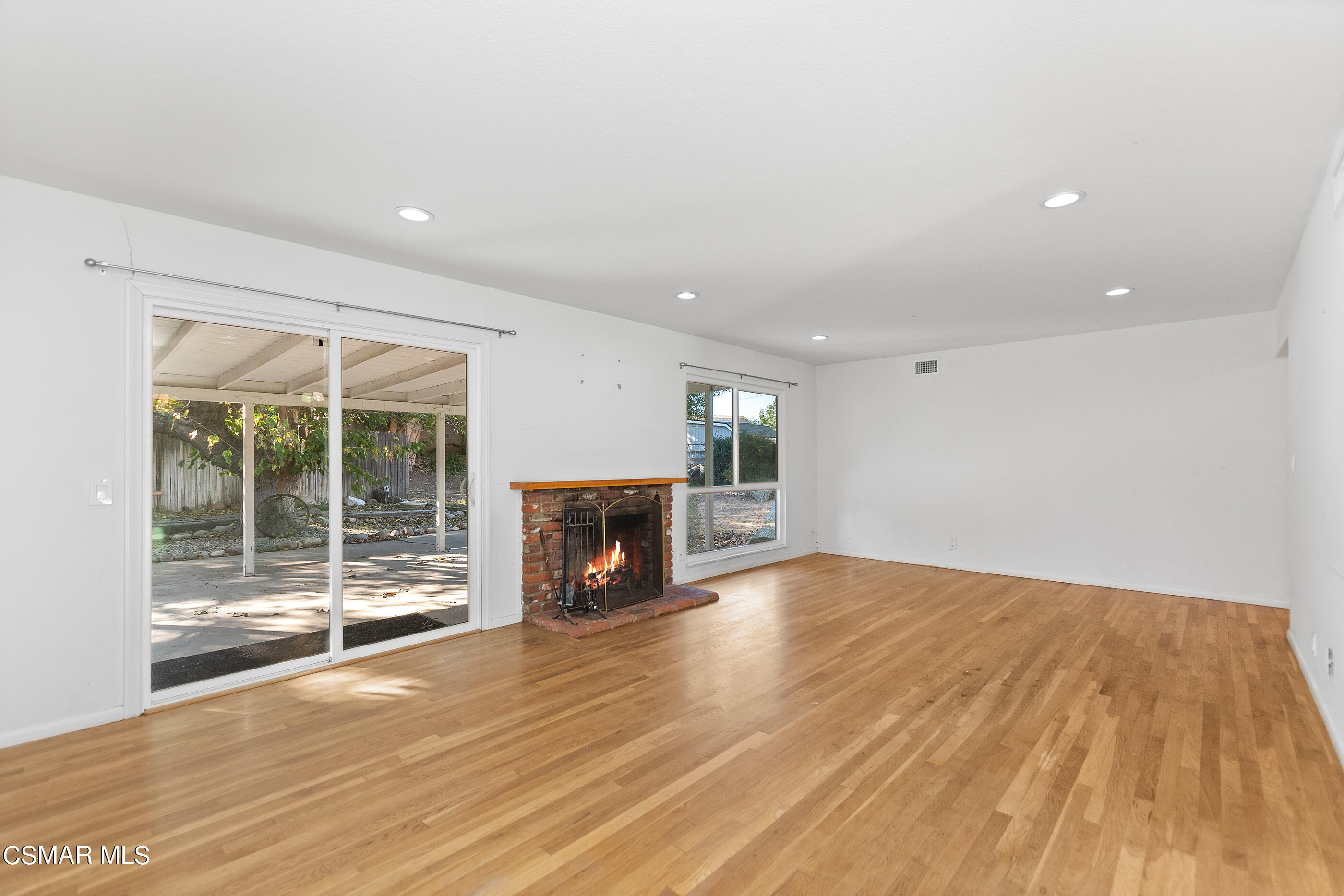 2772 Harrington Road Simi Valley, CA 93065 - Photo 7 of 36 a view of empty room with wooden floor and fireplace