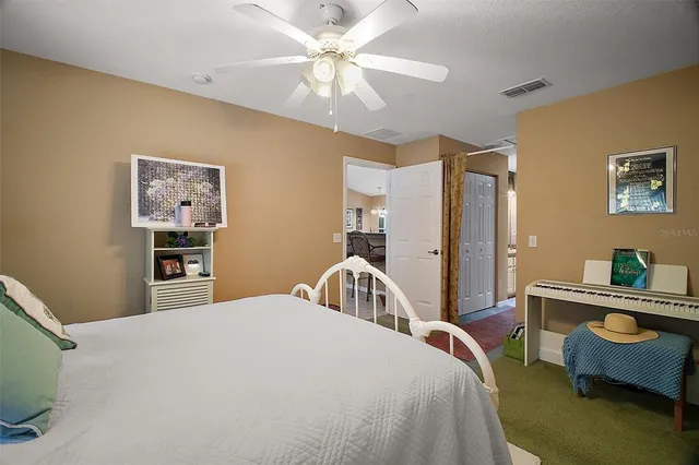 a bedroom with a bed desk and chair