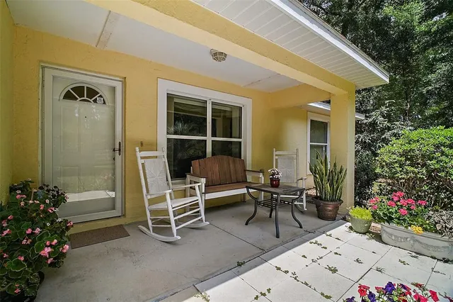 a view of a patio with table and chairs and potted plants