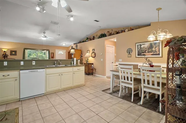 a large white kitchen with a table and chairs