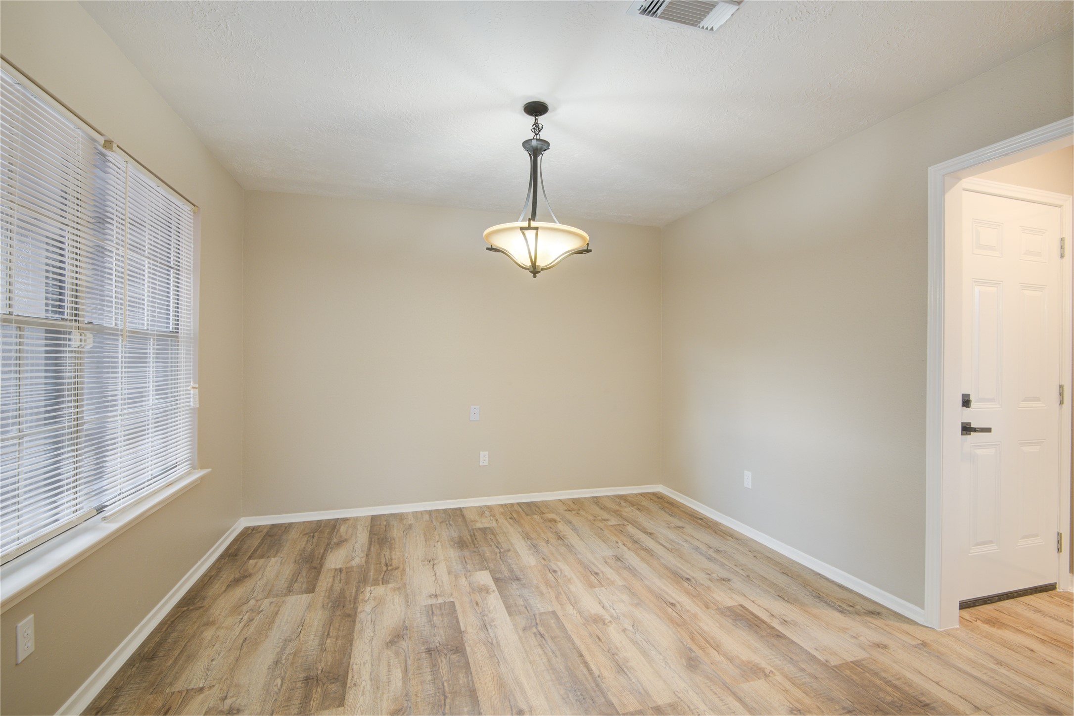 6722 Lynngate Drive Spring, TX 77373 - Photo 11 of 31 a view of a room with wooden floor and windows
