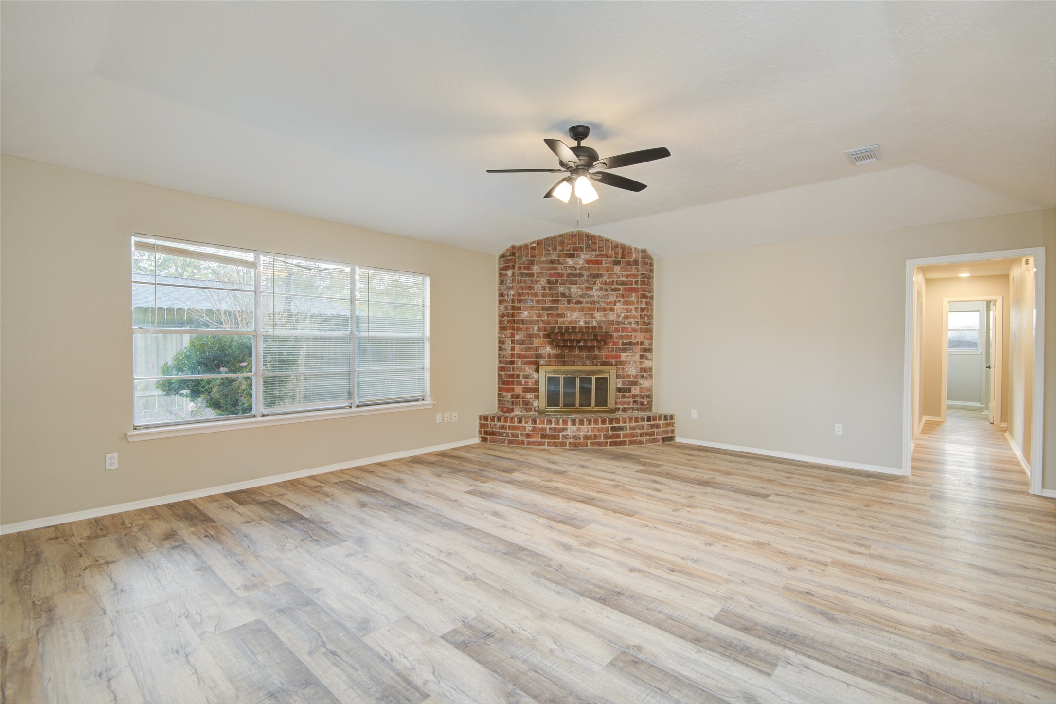 6722 Lynngate Drive Spring, TX 77373 - Photo 15 of 31 a view of an empty room with a window and wooden floor