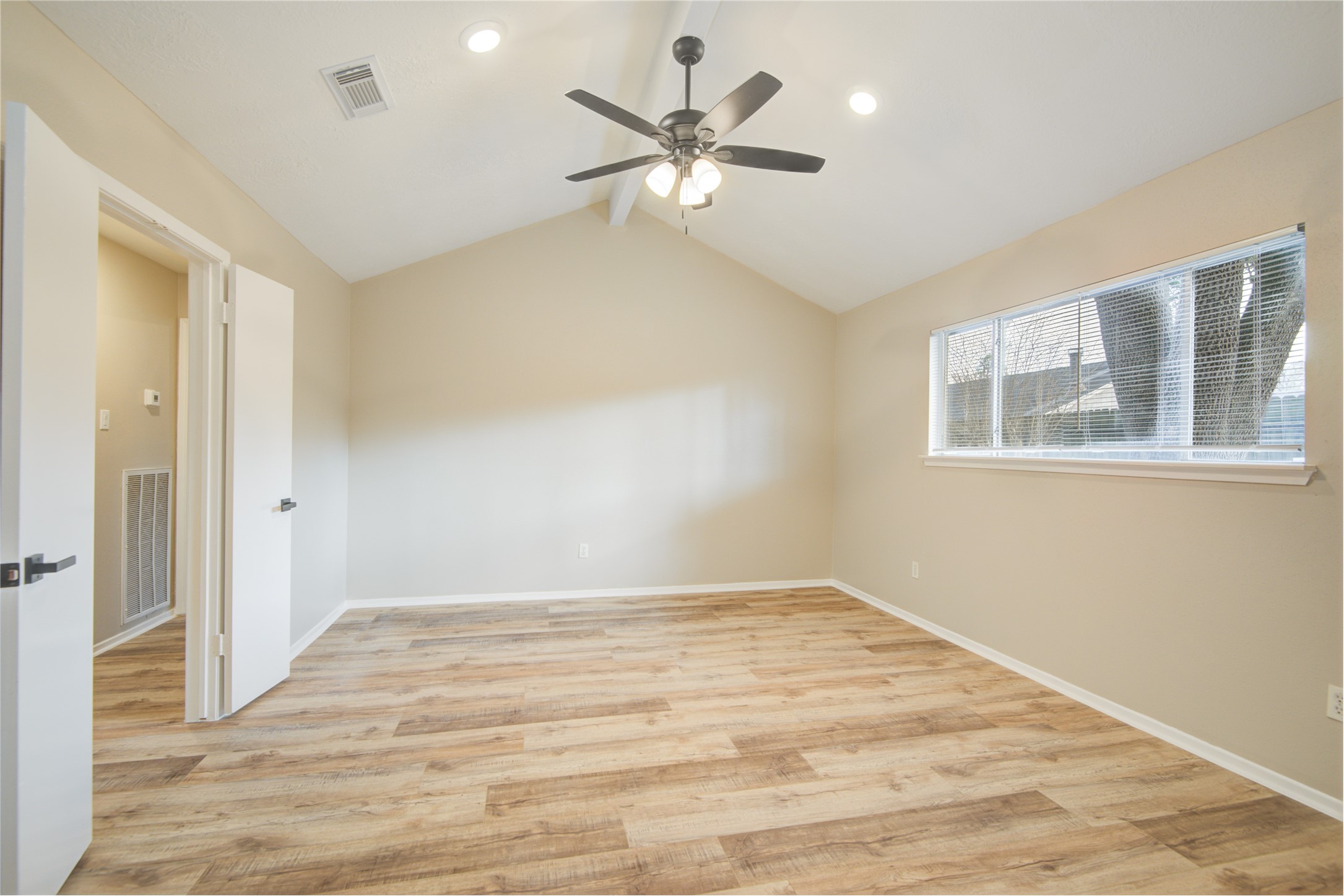 6722 Lynngate Drive Spring, TX 77373 - Photo 18 of 31 a view of an empty room with wooden floor and a ceiling fan
