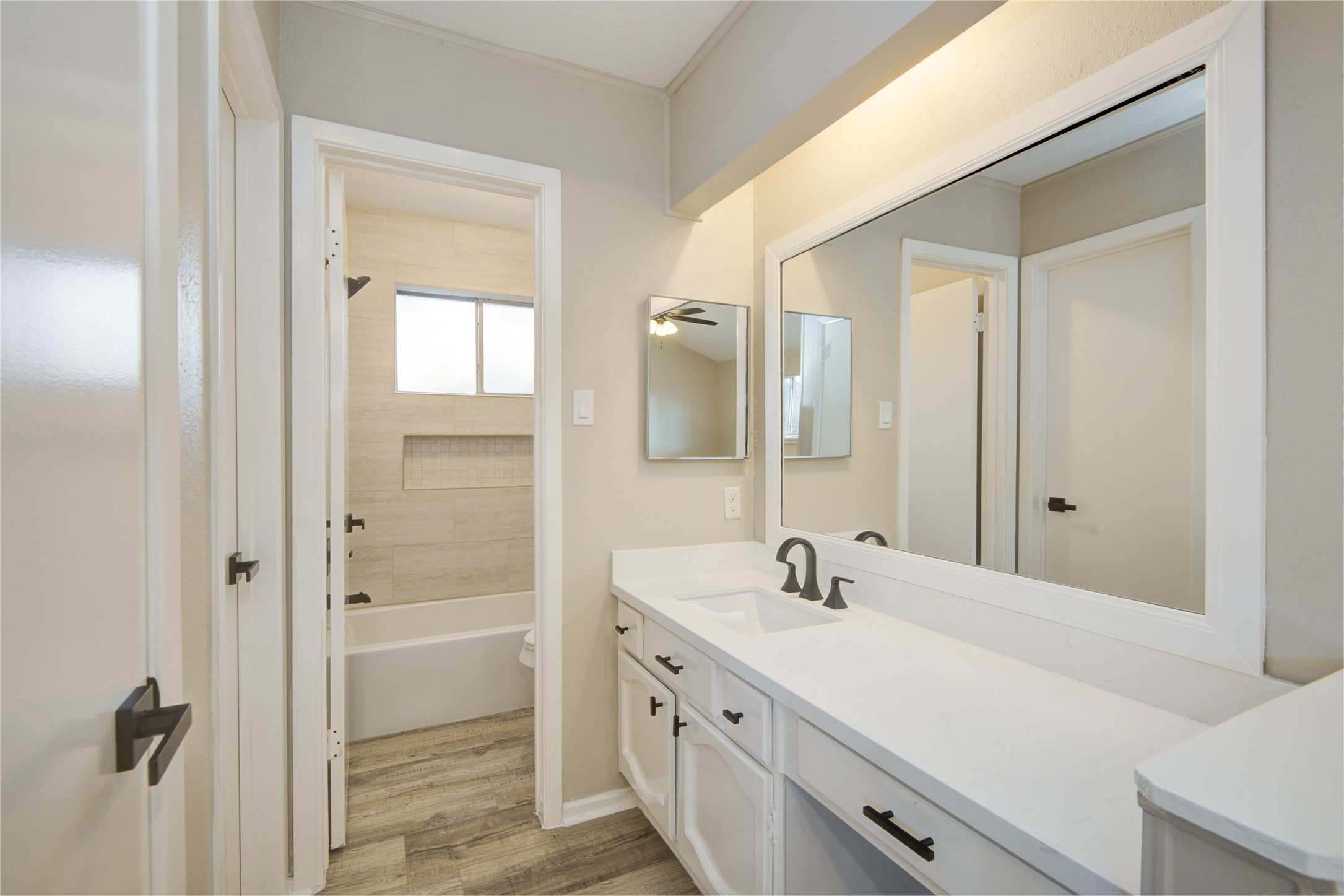 6722 Lynngate Drive Spring, TX 77373 - Photo 19 of 31 a bathroom with a double vanity sink a mirror and a shower