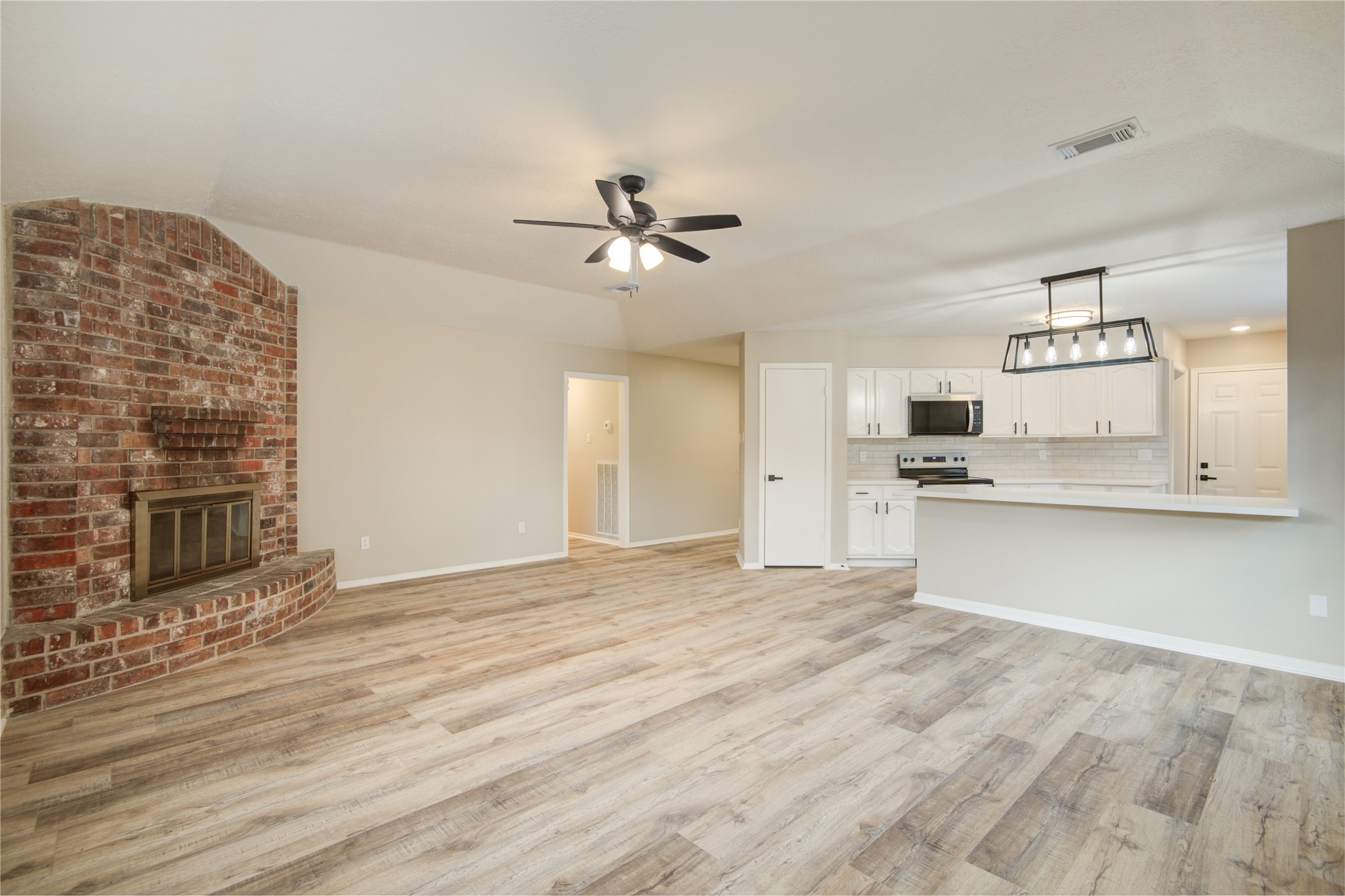 6722 Lynngate Drive Spring, TX 77373 - Photo 5 of 31 a view of a kitchen with microwave and cabinets