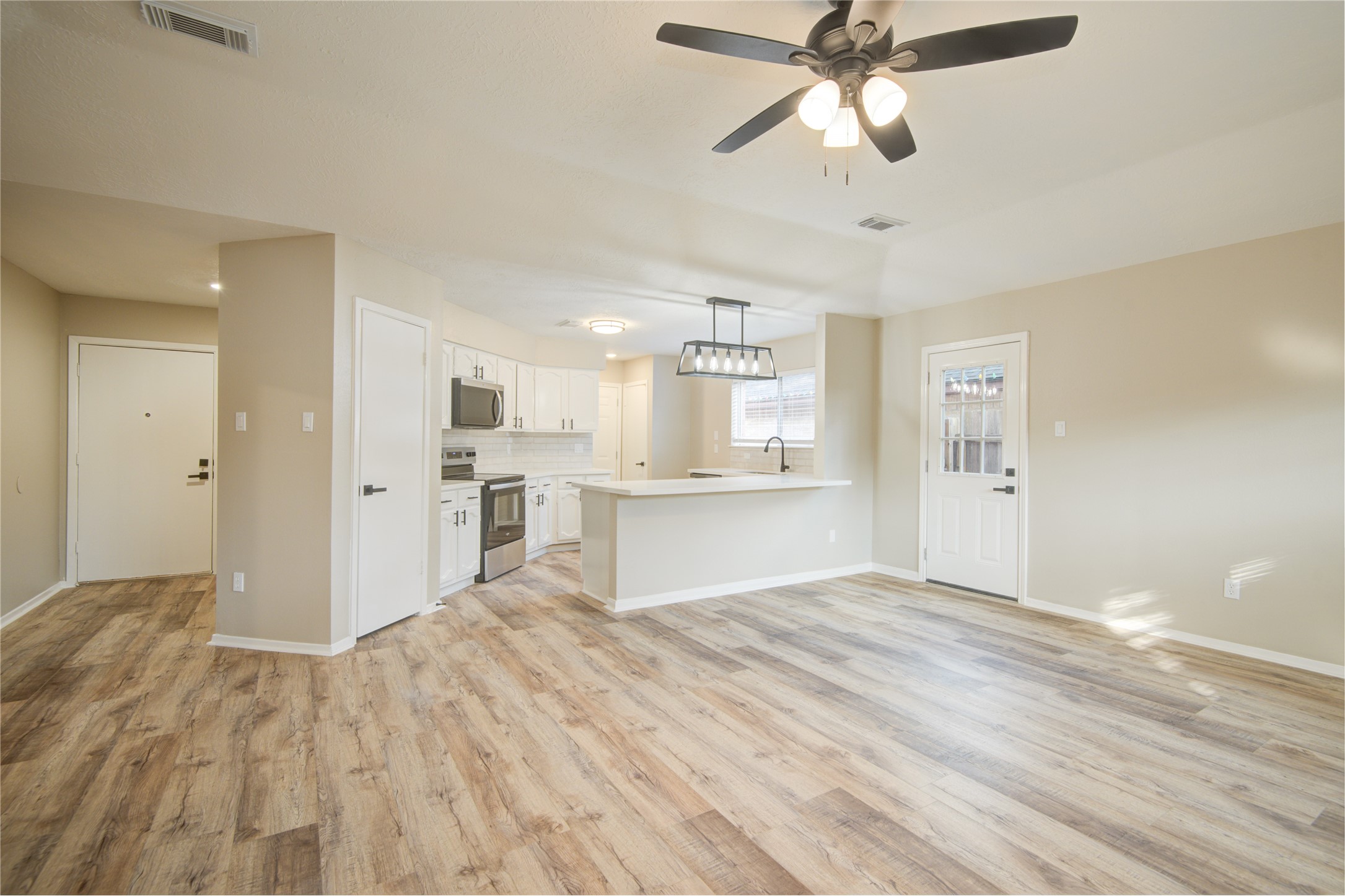 6722 Lynngate Drive Spring, TX 77373 - Photo 6 of 31 a view of kitchen with wooden floor and window