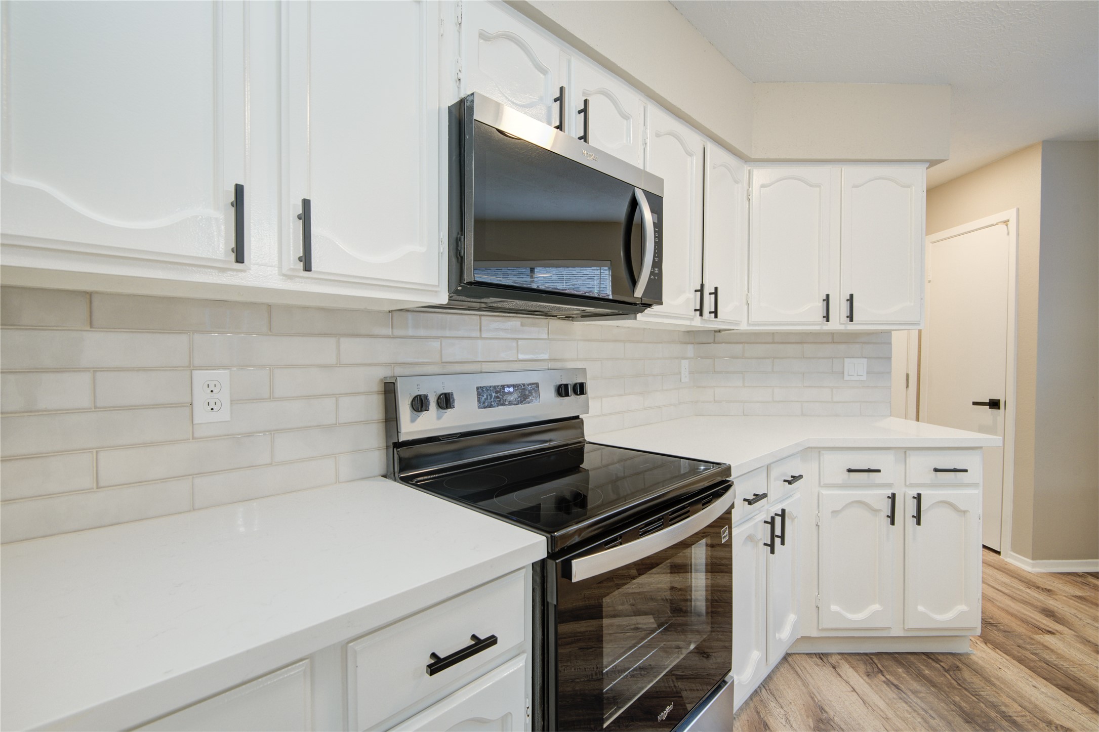 6722 Lynngate Drive Spring, TX 77373 - Photo 9 of 31 a kitchen with white cabinets and appliances