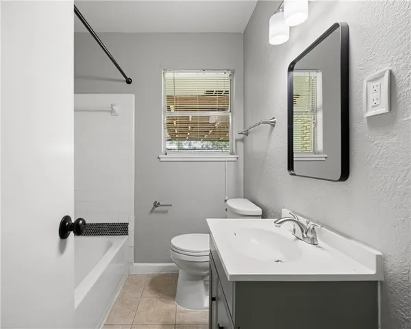 a bathroom with a sink toilet and mirror