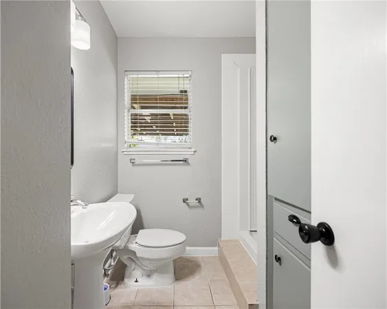 a white toilet sitting next to a bathroom sink