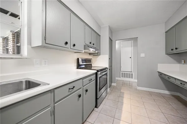 a kitchen with granite countertop a sink and cabinets