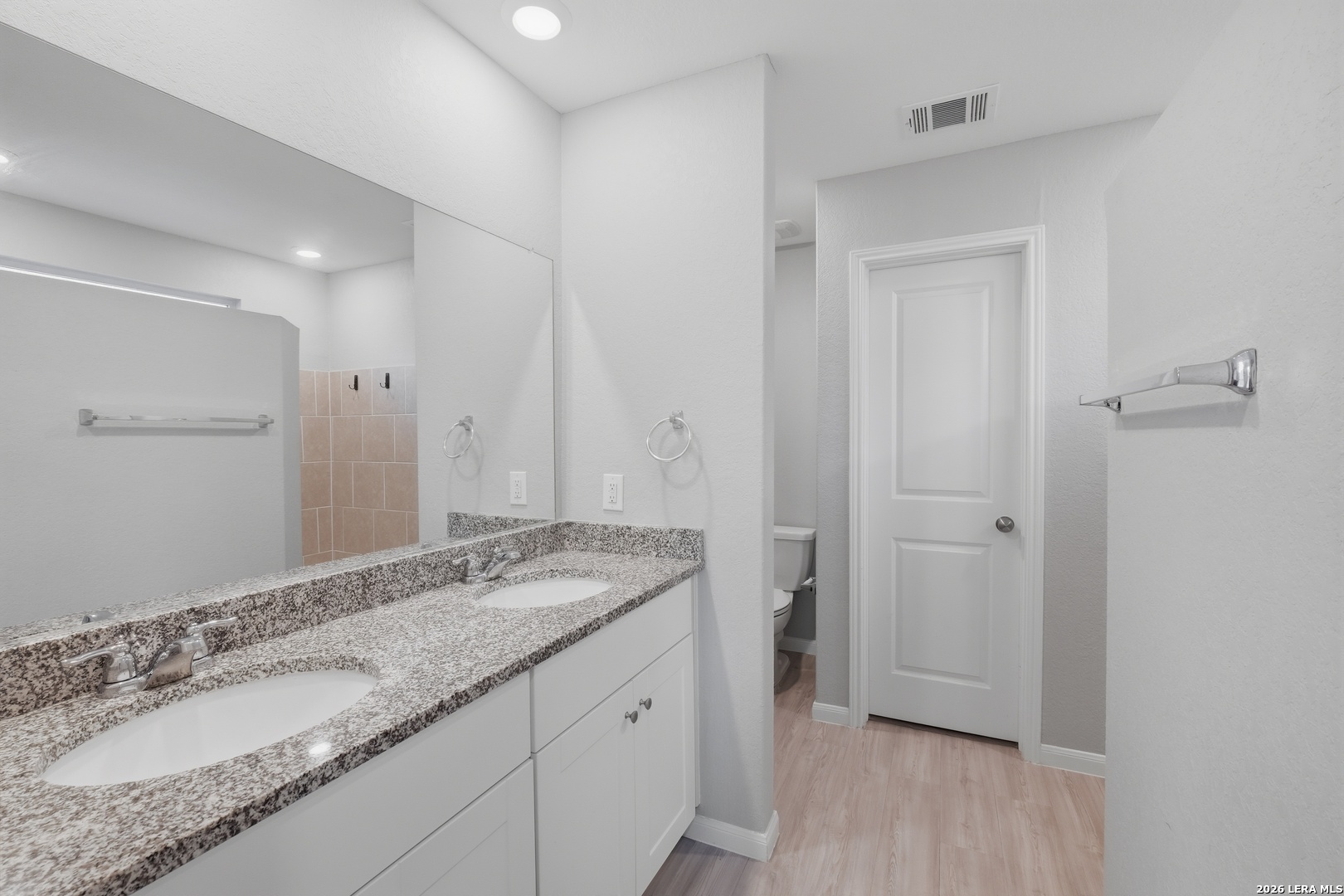31589 Untrodden Way Bulverde, TX 78163 - Photo 17 of 26 a bathroom with a granite countertop sink and a mirror